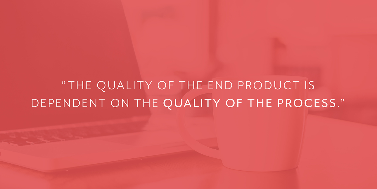 A coffee cup sits next to a laptop with white font that reads, "The quality of the end product is dependent on the quality of the process."