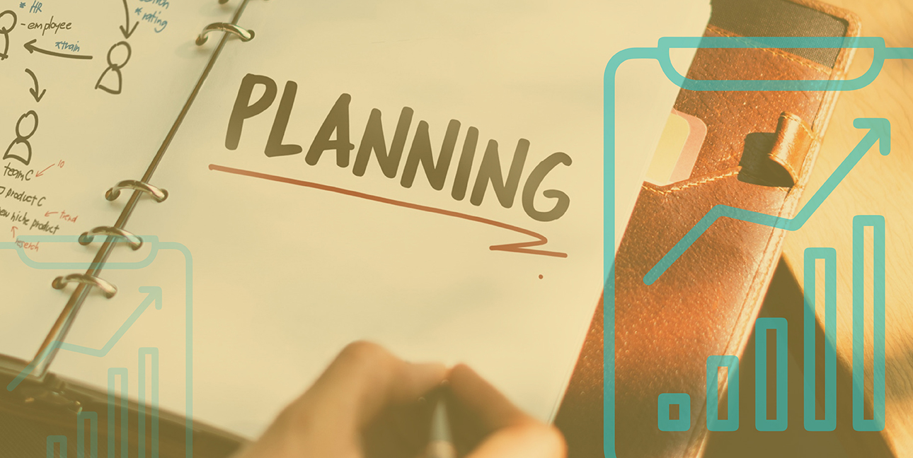 A marketing professional writes on a piece of paper that says, "Planning."