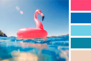 A pink flamingo inner tube floats on the waters of a blue pool.
