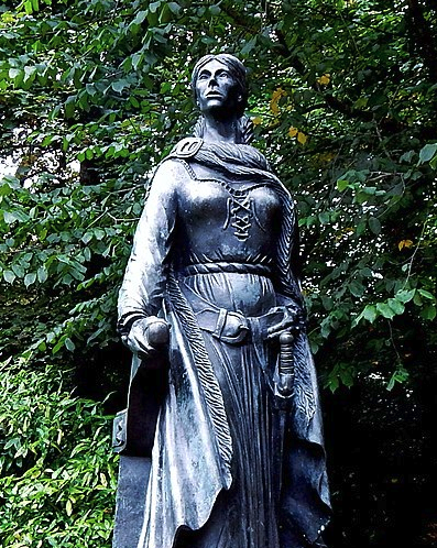 8THIRTYFOUR Blog Women Who Changed The World statue of Grainne Ni Mhaille by trees