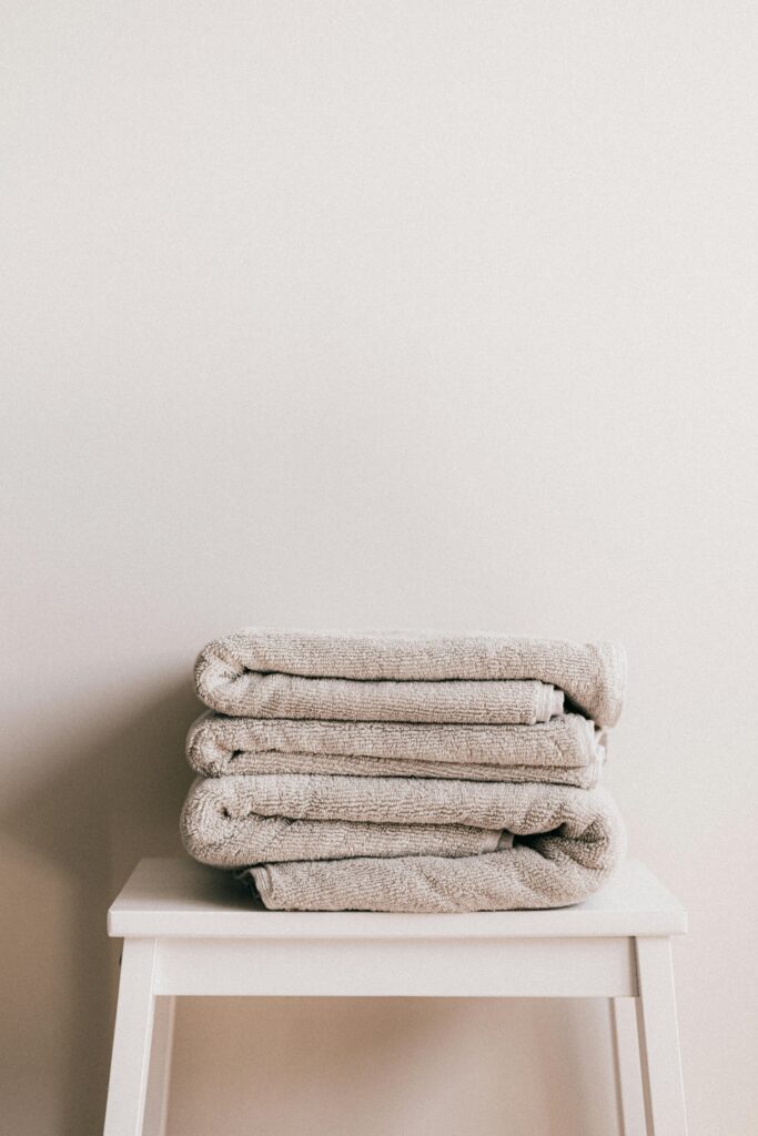 8THIRTYFOUR Blog: Self Care Blog a stack of towels on a stool in a bathroom