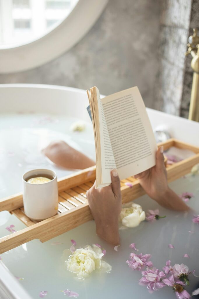 8THIRTYFOUR Blog: Self Care Blog a women in a bathtub reading a book with tea